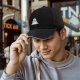 Black baseball cap with a melting snowman graphic for winter style