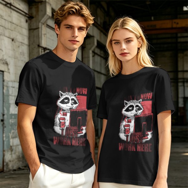 Olive graphic t-shirt with a tired raccoon office worker and 'I Just Work Here' text