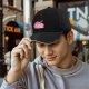 Black baseball cap with pink ramen bowl graphic design