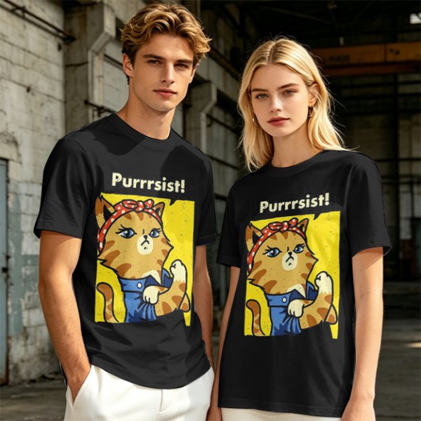 Olive green t-shirt with a cat in a Rosie the Riveter pose and 'Purrrsist!' text