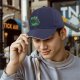 Black baseball cap with alien graphic and 'Kiss Me' text