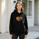 Black hoodie with hugging monkeys inside a heart graphic