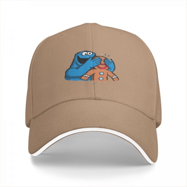 Black baseball cap with Cookie Monster covering a gingerbread man’s eyes