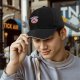 Black baseball cap with sad donut graphic and 'I'M A WEIRD' text