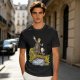 Olive T-shirt with fantasy characters balancing on a log over a stream