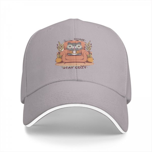 Black baseball cap with cozy raccoon on armchair and stay cozy print