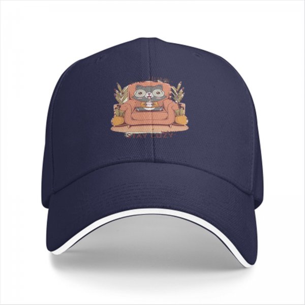 Black baseball cap with cozy raccoon on armchair and stay cozy print