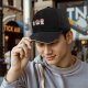 Black baseball cap with cute mushroom creature graphic print