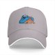 Black baseball cap with Cookie Monster covering a gingerbread man’s eyes