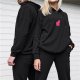Black hoodie with pink cat silhouette graphic