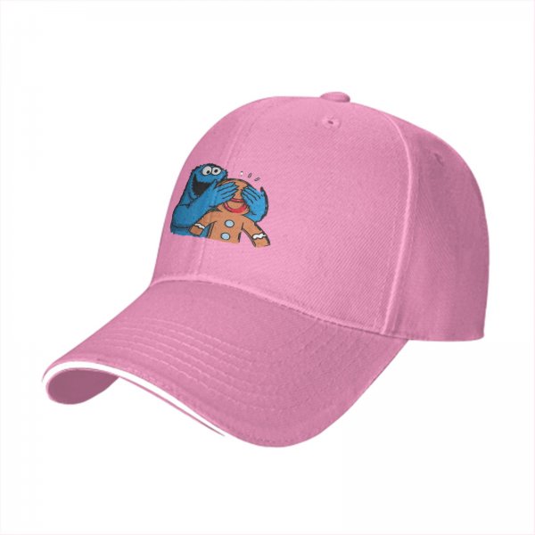 Black baseball cap with Cookie Monster covering a gingerbread man’s eyes