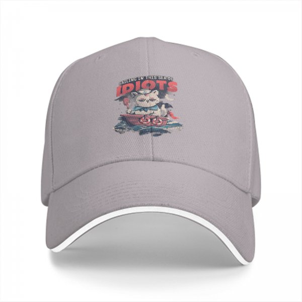 Black baseball cap with sailing cat graphic and 'Sailing in this sea of idiots' text