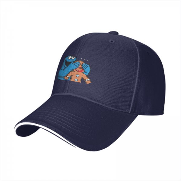 Black baseball cap with Cookie Monster covering a gingerbread man’s eyes