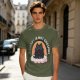 Olive graphic tee with black cat, rainbow, and 'Therapy Is Not Enough' text