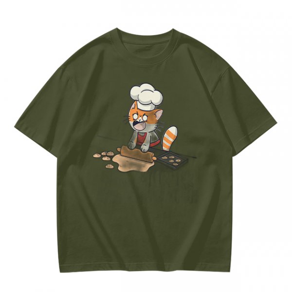 Olive T-shirt with a stressed cartoon cat baking cookies