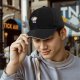 Black baseball cap with grumpy cartoon cat graphic