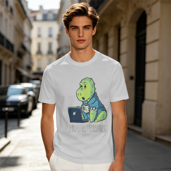 Olive t-shirt with a cartoon dinosaur working on laptop holding coffee