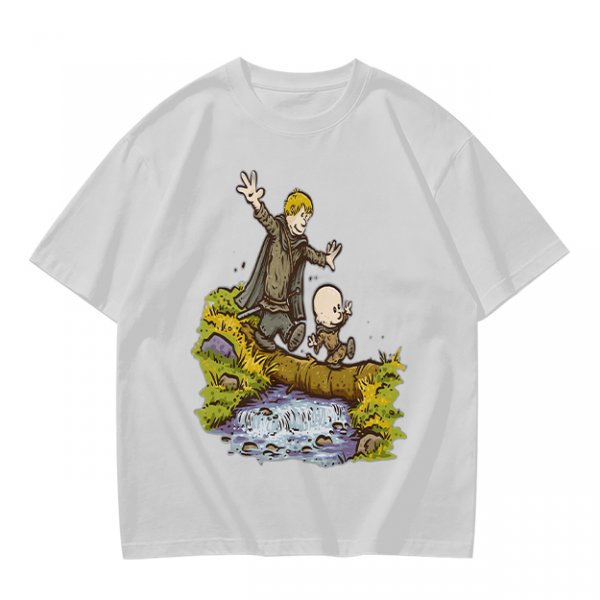 Olive T-shirt with fantasy characters balancing on a log over a stream