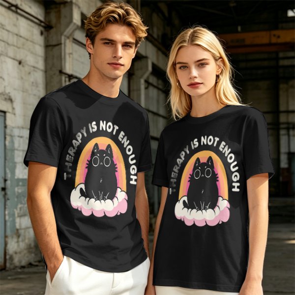 Olive graphic tee with black cat, rainbow, and 'Therapy Is Not Enough' text