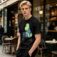 Olive t-shirt with a cartoon dinosaur working on laptop holding coffee
