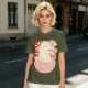 Olive t-shirt with a cartoon dinosaur in a ramen bowl graphic