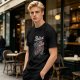 Olive graphic t-shirt with skeleton relaxing on coffin and 'Relax We All Die' text