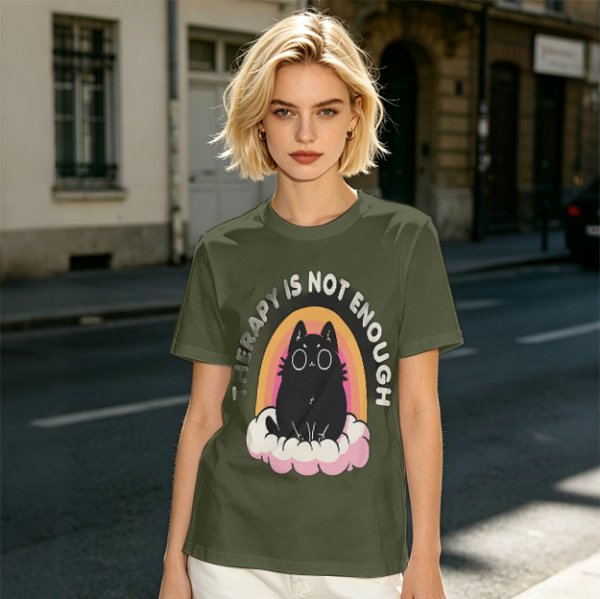 Olive graphic tee with black cat, rainbow, and 'Therapy Is Not Enough' text