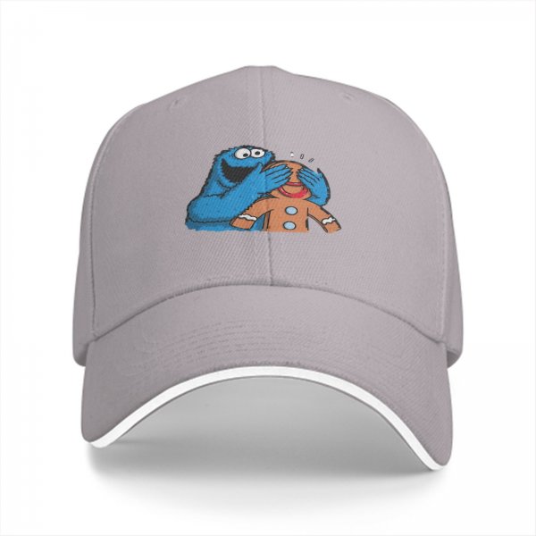 Black baseball cap with Cookie Monster covering a gingerbread man’s eyes
