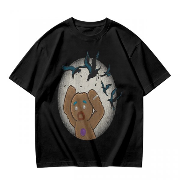 Olive T-shirt with a terrified gingerbread man and flying birds graphic