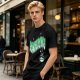 Olive green graphic t-shirt with 'Scandalacious' print and witch hat design