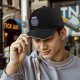 Black baseball cap with cute bat graphic and 'Bite First Ask Later' text
