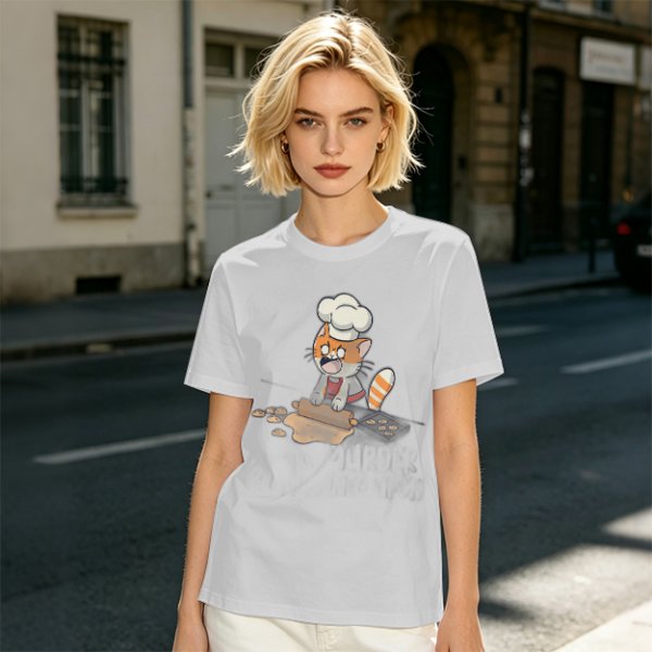 Olive T-shirt with a stressed cartoon cat baking cookies