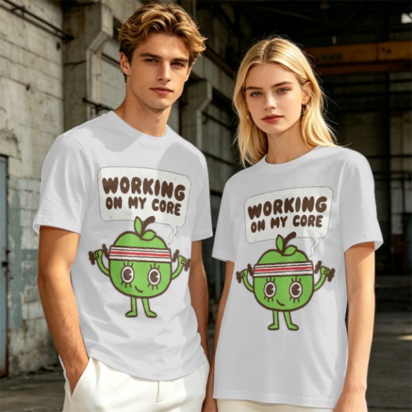 Olive green t-shirt with cartoon apple lifting dumbbells and 'Working on my core' text