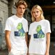 Olive t-shirt with a cartoon dinosaur working on laptop holding coffee