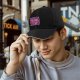 Black baseball cap with pink and purple bear graphic print
