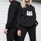 Black hoodie with three stylized white cartoon creatures graphic