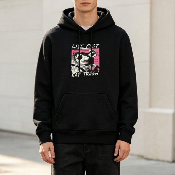 Black hoodie with raccoon driving graphic and 'Live Fast Eat Trash' text