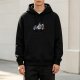 Black hoodie with small colorful cartoon character graphic on chest