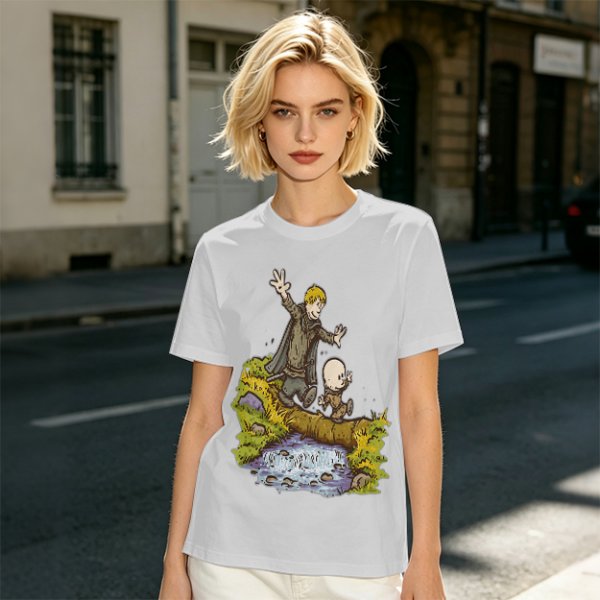 Olive T-shirt with fantasy characters balancing on a log over a stream