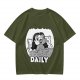 Olive green graphic t-shirt with bedridden cartoon girl and 'DAILY' text