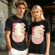 Olive t-shirt with a cartoon dinosaur in a ramen bowl graphic