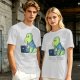 Olive t-shirt with a cartoon dinosaur working on laptop holding coffee