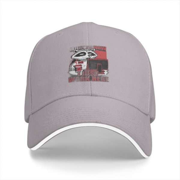 Black baseball cap with a tired raccoon office worker graphic