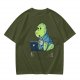 Olive t-shirt with a cartoon dinosaur working on laptop holding coffee