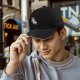 Black baseball cap with running dog graphic and gold text