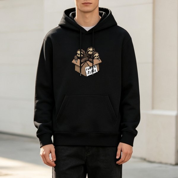 Black hoodie with three sloths in a cardboard box that says Adopt a Sloth