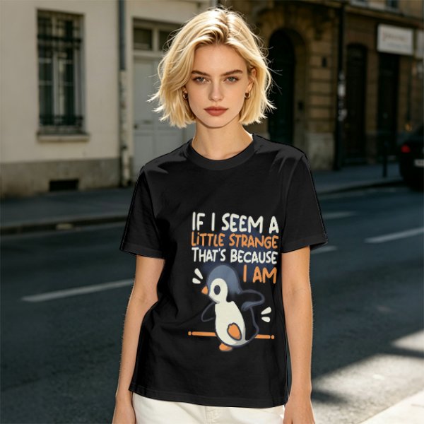 Olive t-shirt with 'If I seem a little strange that's because I am' penguin print