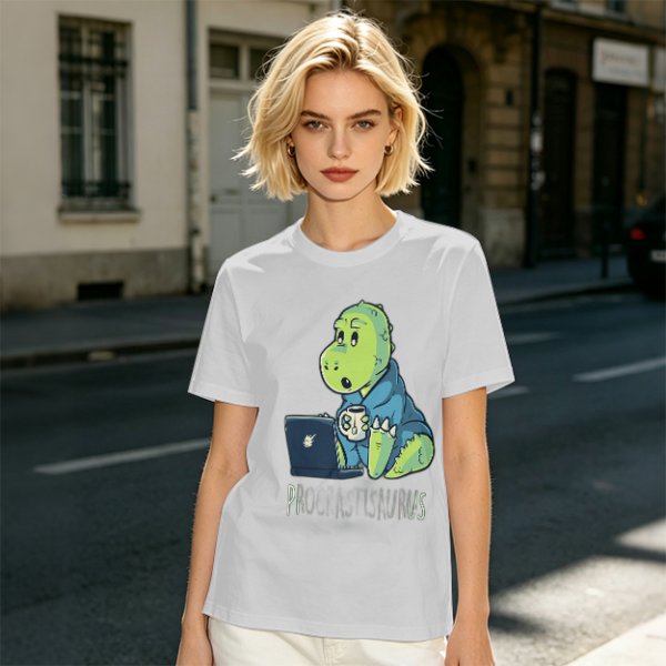 Olive t-shirt with a cartoon dinosaur working on laptop holding coffee