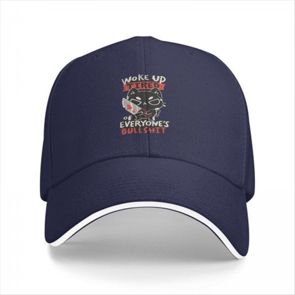 Black baseball cap with a tired cat graphic and humorous text
