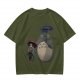 Olive T-shirt with Totoro and masked figure under umbrellas print